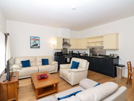 A living room with a kitchen area and seating at Chestnut Cottage in Bridlington
