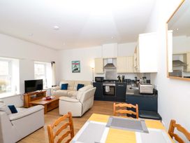 A living room with a sofa and tv at Chestnut Cottage in Bridlington