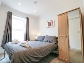 A bedroom with a bed and wardrobe at Chestnut Cottage in Bridlington