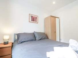 A bedroom with a bed and wardrobe at Chestnut Cottage in Bridlington