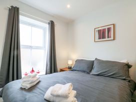 A bedroom with bed and lamp at Chestnut Cottage in Bridlington