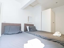 A bedroom with two beds and towels at Chestnut Cottage in Bridlington