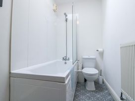 A bathroom with a bathtub and a toilet at Chestnut Cottage in Bridlington