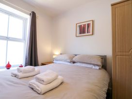 A bedroom with a bed and towels arranged at Chestnut Cottage in Bridlington