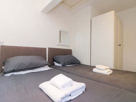 A bedroom with two beds and towels arranged at Chestnut Cottage in Bridlington