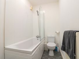 A bathroom with a bathtub and toilet at Chestnut Cottage in Bridlington