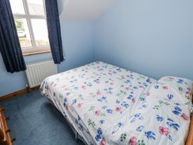 A bedroom with a bed and curtains at 22 White Maples, Bundoran, County Donegal
