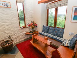 A snug area with seating and decorative flowers at The Dovecote Llanychaer near Fishguard