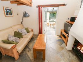 A living room with a sofa and coffee table at The Dovecote in Llanychaer near Fishguard