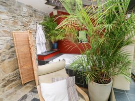 A bathroom with a bathtub and plant at The Dovecote in Llanychaer near Fishguard
