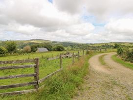 A pathway leading through a field with a fence and solar panels at The Dovecote Llanychaer near Fishguard