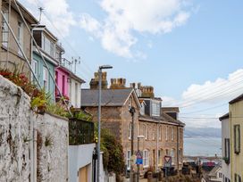 A street view with houses and signs at Captains Cottage in Brixham