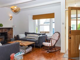 A living room with a sofa and coffee table at Captains Cottage in Brixham
