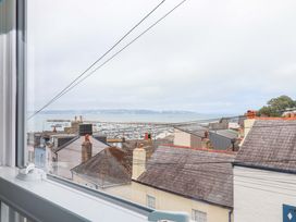 A view of the ocean and rooftops from a window at Captains Cottage in Brixham