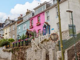 A street with colorful houses and flower pots at Captains Cottage Brixham