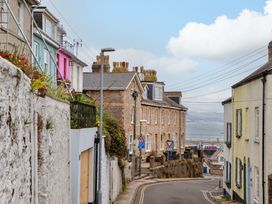 A street view of houses with a slope and traffic signs in Brixham