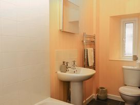 A bathroom with a sink and toilet at Captains Cottage in Brixham