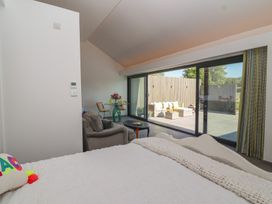 A bedroom with a view of an outdoor seating area at Noflash Malpal in Bristol
