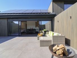 An outdoor patio with seating and a fire pit at Noflash Malpal in Bristol