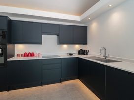 A kitchen with cabinets, sink, and appliances at Noflash Malpal in Bishop Sutton