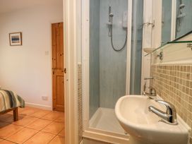 A bathroom with a shower and sink at Tater-Du in Porthcurno