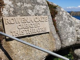 A stone plaque by the sea with text at Tater-Du in Porthcurno near Land’s End