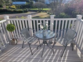A patio with two chairs and a table at Tater-Du Porthcurno near Land’s End
