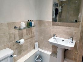 A bathroom with toilet, sink, and shower at Bush Nook House in Brampton