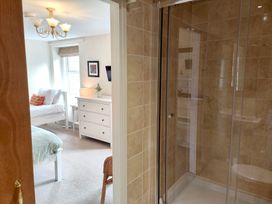 A bathroom with a shower and a view of a bedroom at Bush Nook House in Brampton