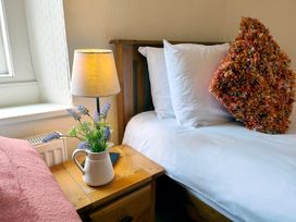 A bedroom with a bed and a lamp on a nightstand at Bush Nook House in Brampton