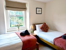 A bedroom with two beds and a window at Bush Nook House in Brampton