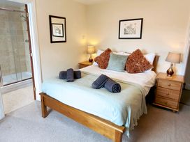 A bedroom with a bed and en-suite shower at Bush Nook House in Brampton