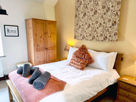 A bedroom with a bed and wardrobe at Bush Nook House in Brampton