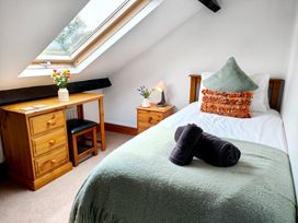 A bedroom with a bed and desk at Bush Nook House Brampton