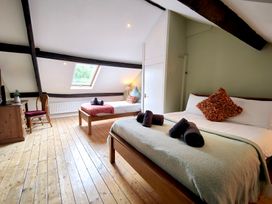 A bedroom with two beds and a television at Bush Nook House in Brampton