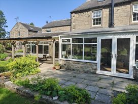 A garden with patio and wooden structure at Bush Nook House Brampton, Cumbria