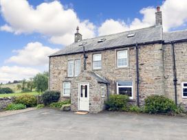 A house with stone exterior and garden at Bush Nook House in Brampton, Cumbria