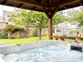 A hot tub in a garden at Bush Nook House in Brampton, Cumbria