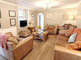A living room with sofas and a coffee table at Bush Nook House in Brampton, Cumbria