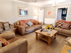 A living room with sofas and a coffee table at Bush Nook House in Brampton, Cumbria