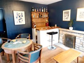 A snug with a bar setup and seating at Bush Nook House in Brampton, Cumbria