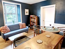 A dining room with a sofa and table at Bush Nook House, Brampton, Cumbria
