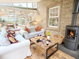 A snug with a couch and coffee table at Bush Nook House in Brampton, Cumbria