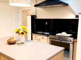 A kitchen with an island, oven and stove at Bush Nook House in Brampton, Cumbria