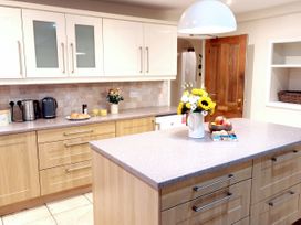 A kitchen with cabinets and a countertop at Bush Nook House in Brampton, Cumbria