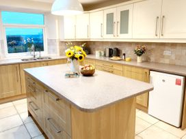 A kitchen with a countertop and cabinets at Bush Nook House in Brampton, Cumbria