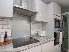 A kitchen with a cooktop and oven at Moot Cottage in Driffield