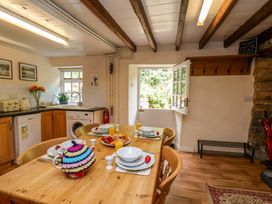 A kitchen with a dining table set for breakfast at 5 Hollins Cottages in Whitby