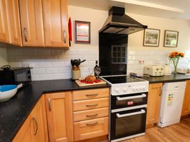 A kitchen with appliances and food items at 5 Hollins Cottages Whitby