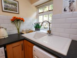 A kitchen with a sink and kettle at 5 Hollins Cottages in Whitby